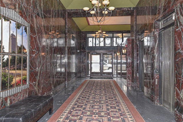 interior space featuring a high ceiling and a chandelier