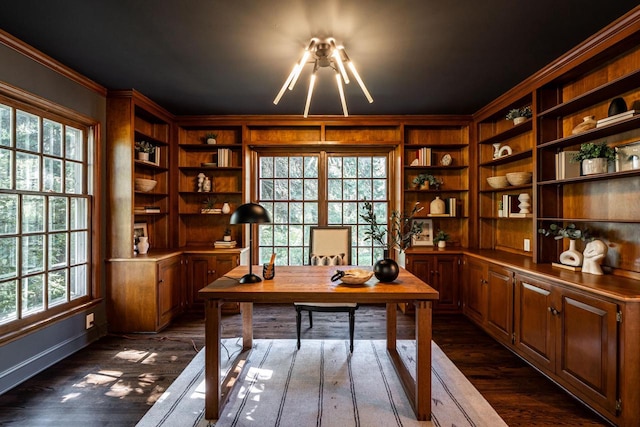 office area with built in shelves, a wealth of natural light, and ornamental molding