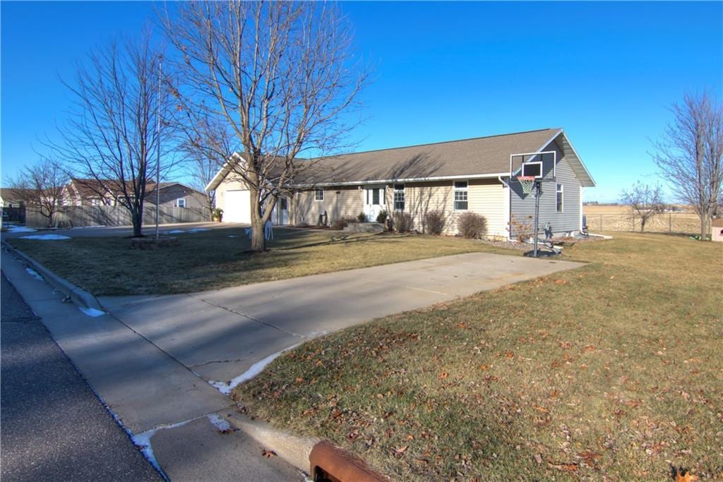 ranch-style house with a front yard and a garage