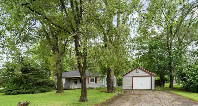 view of front of house with a garage, an outdoor structure, and a front yard