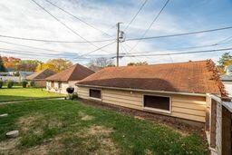 view of side of property with a lawn