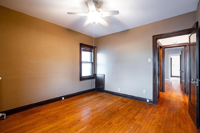 empty room featuring ceiling fan and hardwood / wood-style flooring