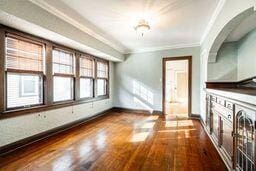 additional living space featuring hardwood / wood-style floors