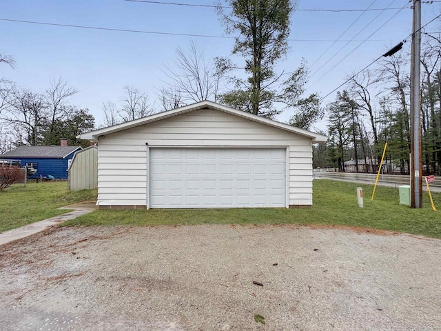 garage featuring a lawn