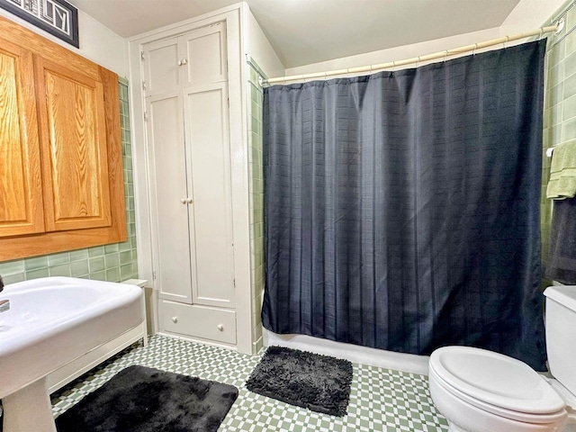 bathroom with shower / tub combo and toilet