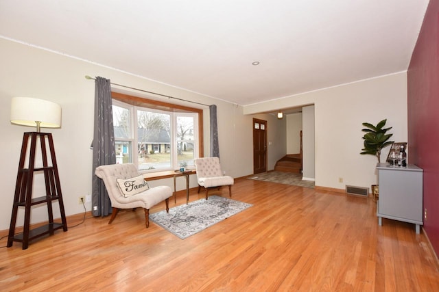 sitting room featuring light hardwood / wood-style flooring