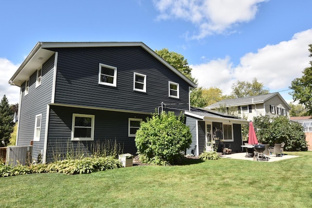 rear view of property featuring a lawn, cooling unit, and a patio