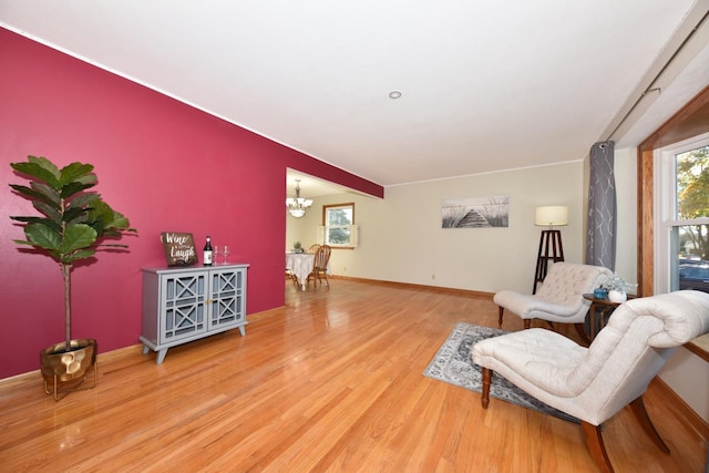 sitting room with a chandelier and wood-type flooring