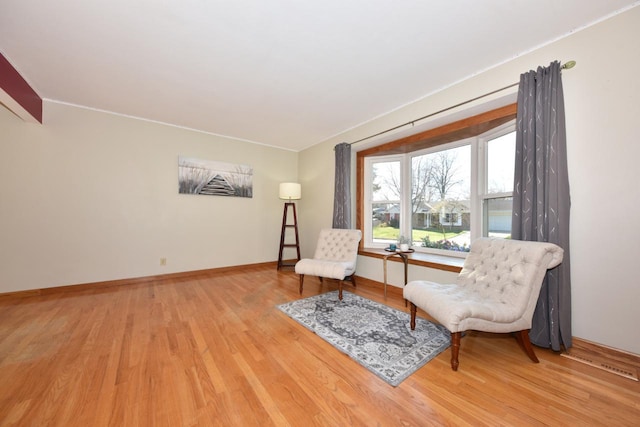 sitting room with hardwood / wood-style flooring