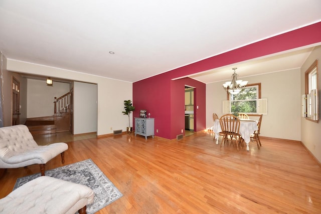 living room featuring hardwood / wood-style floors and an inviting chandelier