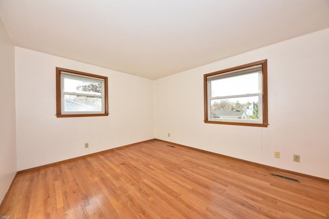 unfurnished room with light wood-type flooring