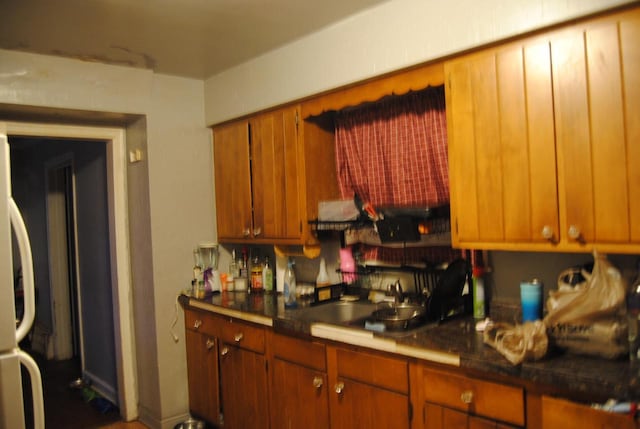 kitchen with sink and white fridge