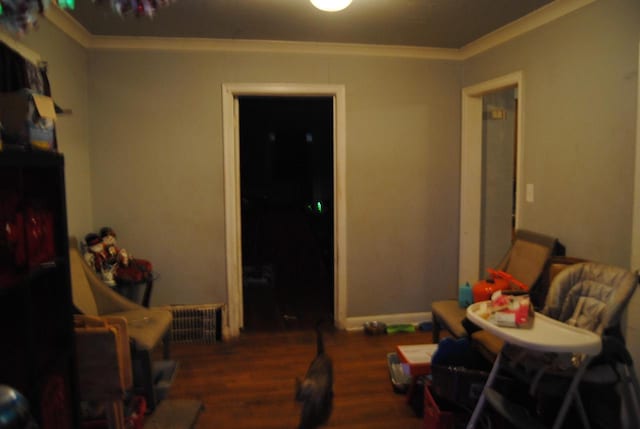 dining area with crown molding, radiator, and dark wood-type flooring