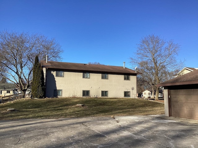 view of side of property with a lawn