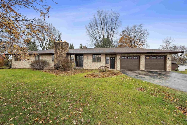 ranch-style home featuring a garage and a front yard