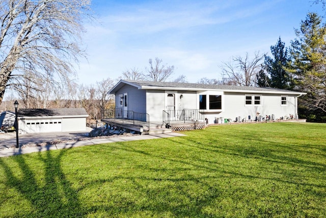 view of front of house with a front lawn, an outdoor structure, and a garage