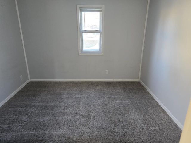 empty room with dark colored carpet