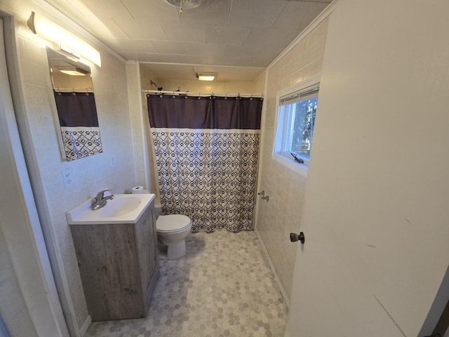 bathroom with a shower with curtain, vanity, tile walls, and toilet