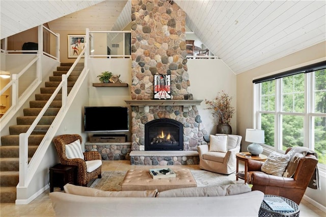 living room with a stone fireplace, wood ceiling, and vaulted ceiling