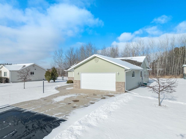 view of snowy exterior with a garage