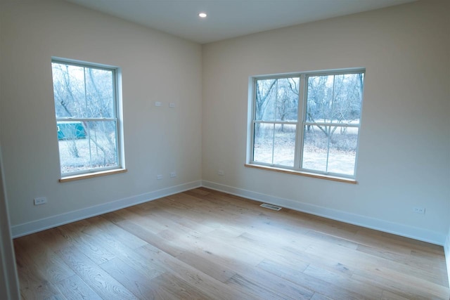 spare room with light hardwood / wood-style floors