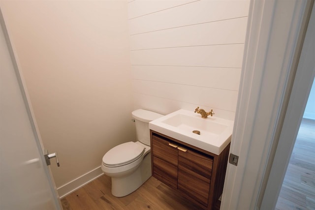 bathroom with vanity, wood-type flooring, and toilet