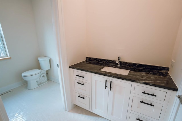 bathroom featuring tile patterned floors, vanity, and toilet