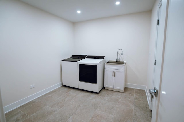 washroom featuring cabinets, separate washer and dryer, and sink