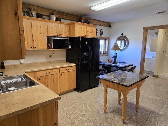 kitchen featuring black appliances, sink, and light brown cabinetry