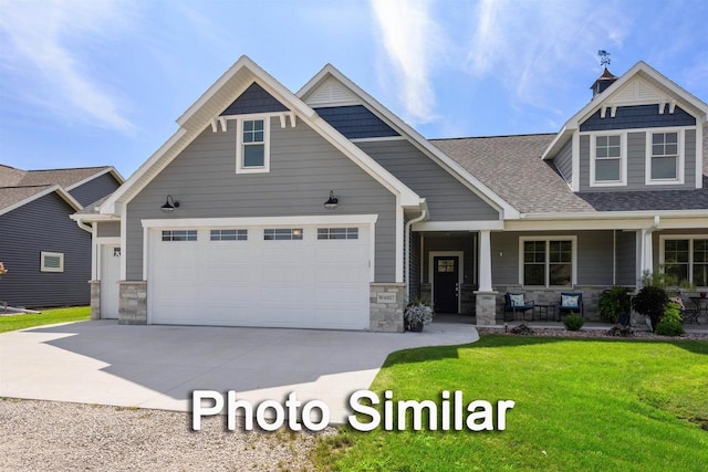 craftsman inspired home with a porch, a garage, and a front lawn