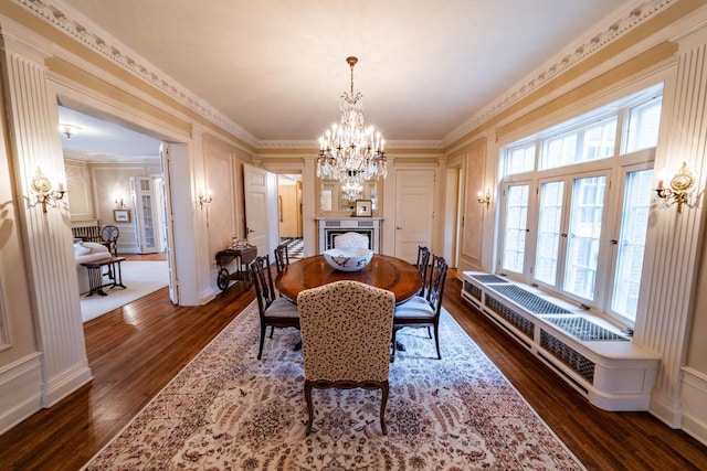 304 Braebourne Ct, Green Bay, WI 54301 - dining space featuring dark hardwood / wood-style floors, an inviting chandelier, a healthy amount of sunlight, and crown molding