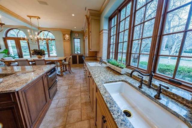 304 Braebourne Ct, Green Bay, WI 54301 - kitchen with crown molding, sink, light stone counters, and decorative light fixtures