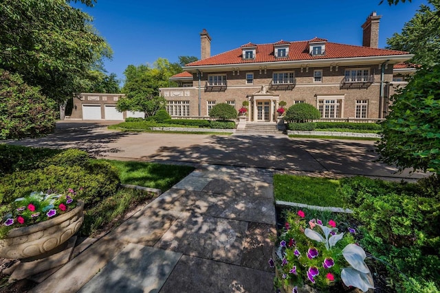 view of front of home featuring an outbuilding, french doors, and a garage