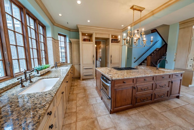 304 Braebourne Ct, Green Bay, WI 54301 - kitchen with pendant lighting, light stone counters, sink, and a large island with sink