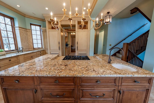304 Braebourne Ct, Green Bay, WI 54301 - kitchen featuring a kitchen island with sink, black gas stovetop, light stone countertops, ornamental molding, and decorative light fixtures