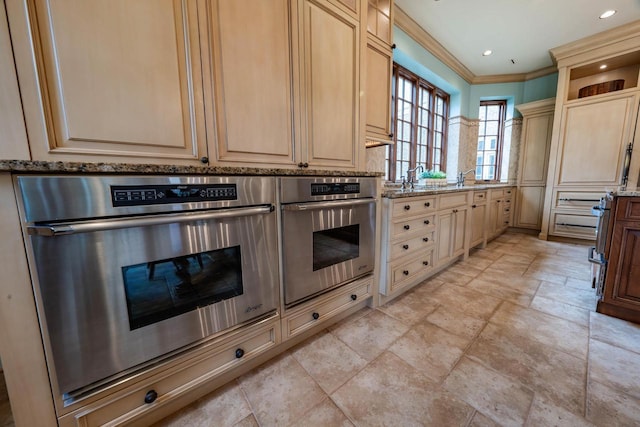 304 Braebourne Ct, Green Bay, WI 54301 - kitchen with light stone counters, stainless steel oven, light brown cabinets, and ornamental molding