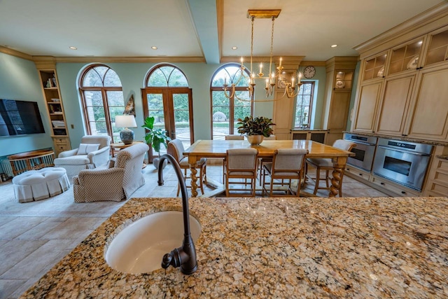 304 Braebourne Ct, Green Bay, WI 54301 - dining area featuring beam ceiling, french doors, a notable chandelier, and sink