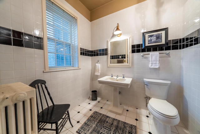 304 Braebourne Ct, Green Bay, WI 54301 - bathroom with tile patterned floors, radiator, tile walls, and toilet