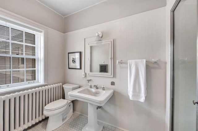 304 Braebourne Ct, Green Bay, WI 54301 - bathroom featuring tile patterned flooring, radiator heating unit, toilet, and a healthy amount of sunlight