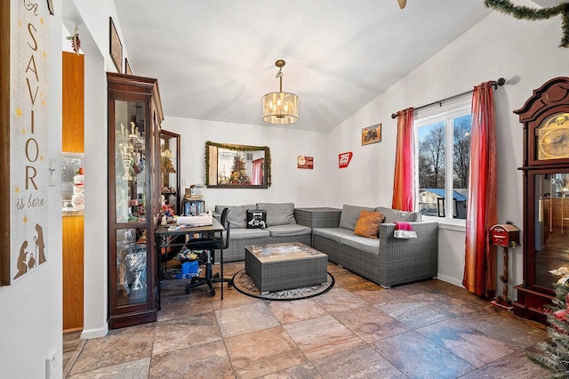 living room featuring a chandelier and lofted ceiling