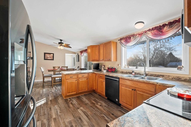 kitchen with kitchen peninsula, ceiling fan, sink, dishwasher, and stainless steel refrigerator