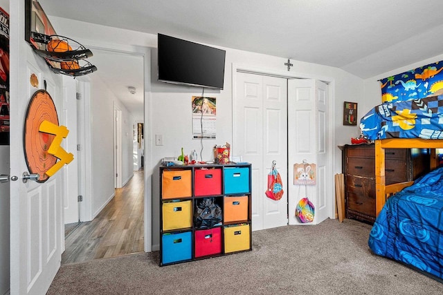 bedroom featuring a closet, carpet, and vaulted ceiling