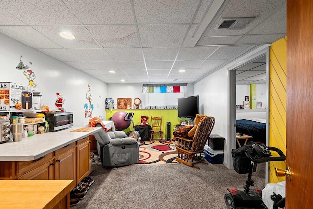 playroom with a paneled ceiling and carpet floors