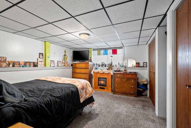 carpeted bedroom featuring a paneled ceiling