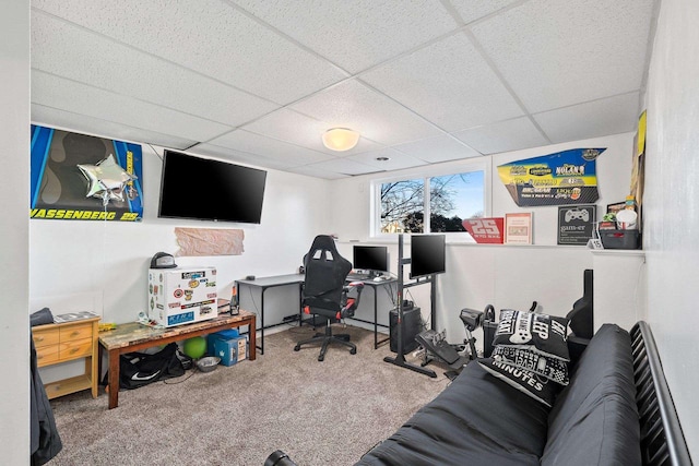 carpeted home office featuring a paneled ceiling