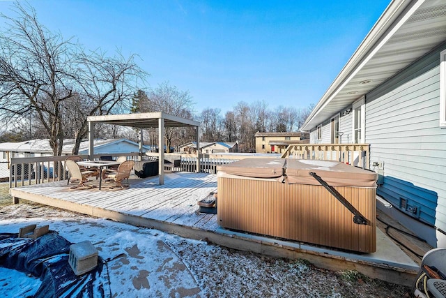 snow covered deck featuring a hot tub