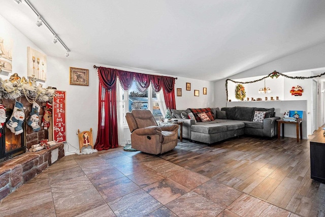 living room with lofted ceiling and a fireplace