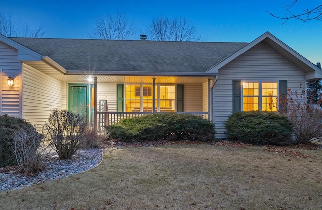 back of property featuring a porch and a yard