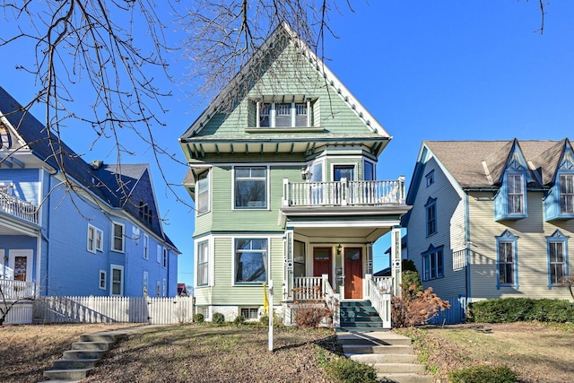 victorian house with a balcony and covered porch