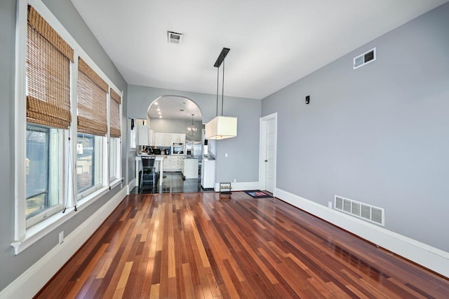 unfurnished living room featuring dark hardwood / wood-style floors